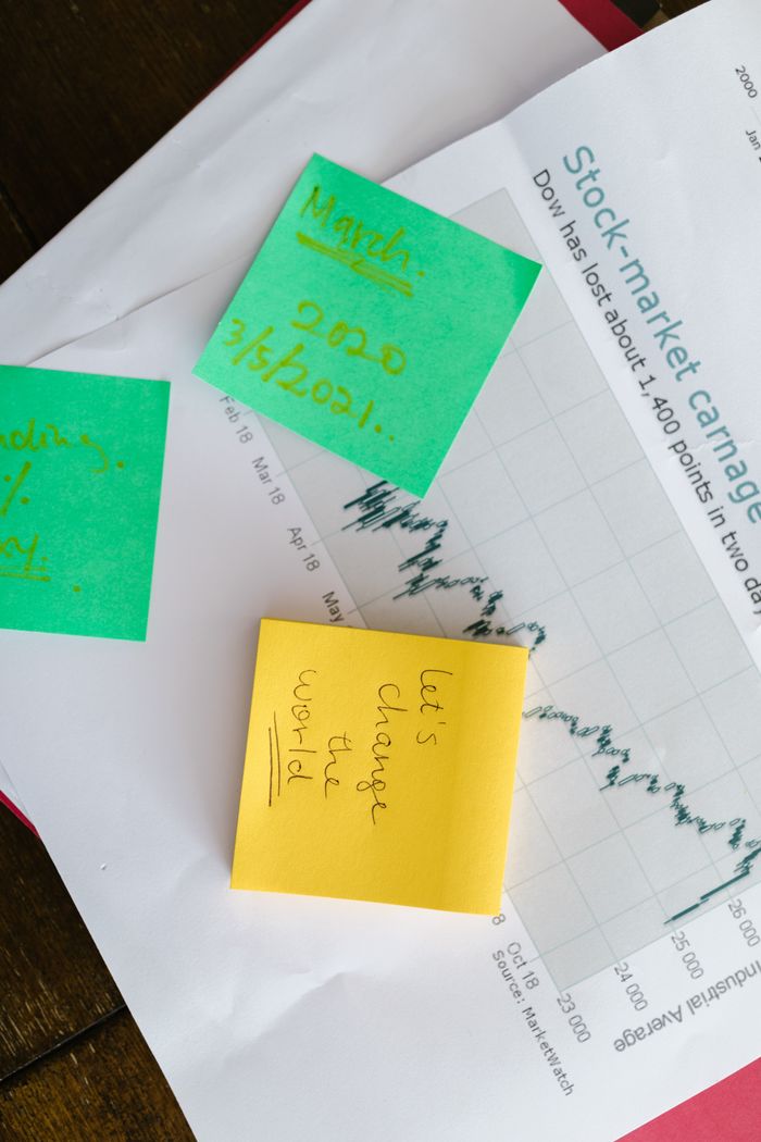 our-story Top-view of colorful sticky notes on a stock market graph paper, symbolizing business and financial planning.